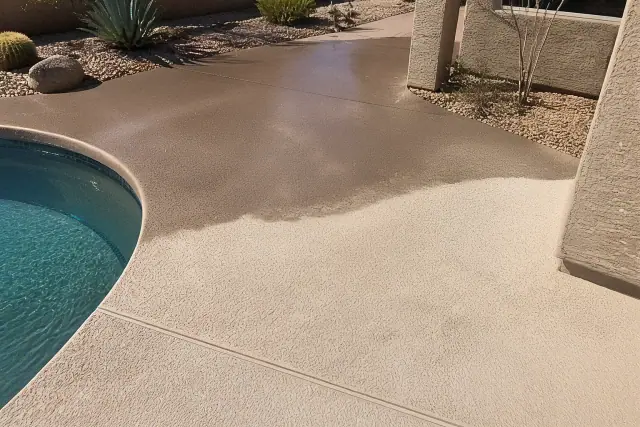 Concrete pool deck in Tempe, AZ showing the difference between stained concrete and a clean, non-slip finished surface.