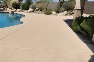 Clean concrete pool deck after professional cleaning with desert landscaping in Phoenix, AZ.