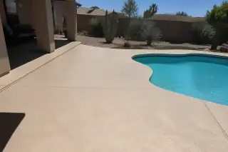 Cleaned concrete pool deck and patio with desert landscaping in Phoenix, AZ.