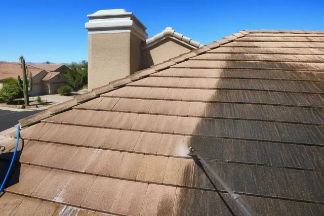 Half-cleaned roof shingles showing a contrast between algae-stained and clean areas at a home in Scottsdale, AZ.