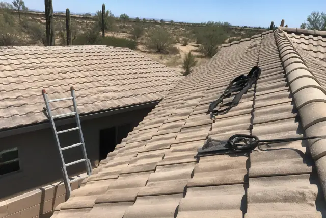 Comparison of a single-story tile roof with a ladder and a steep roof with safety harness in Phoenix, AZ.