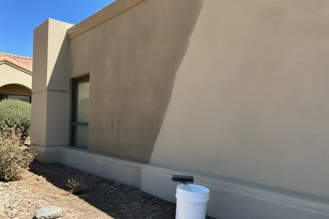 Stucco and EIFS facade restoration on an industrial building in Phoenix, AZ, showing cleaned and weathered wall sections.