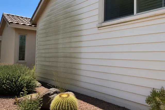 Half-cleaned vinyl siding on a residential home in Phoenix, AZ, showing the difference between mildew and clean surfaces.