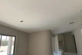 Finished ceiling drywall repair with seamless painted transitions in a Phoenix, AZ home.