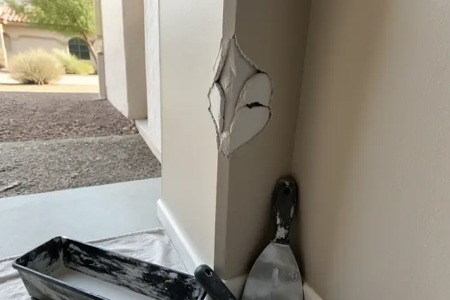 Damaged drywall corner with exposed gypsum being prepped for repair at a jobsite in Phoenix, AZ.