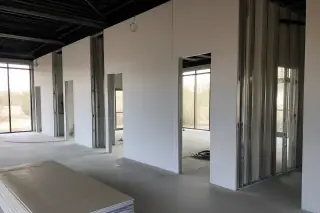 Metal stud office wall framing with partial gypsum board installation in a Phoenix, AZ commercial space.