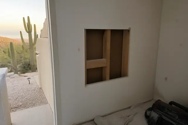 Drywall patch repair with wood backing visible in an interior wall in Phoenix, AZ.