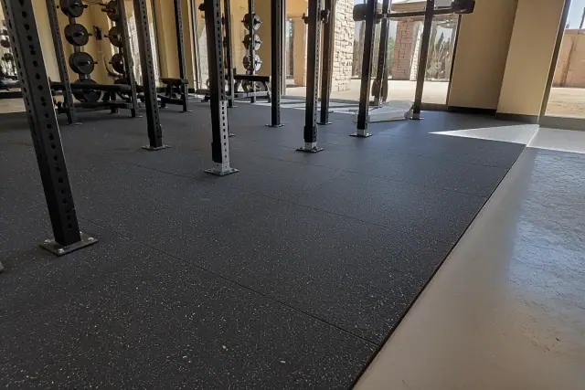 New rubber flooring installation with precise tile cuts at a fitness center in Chandler, AZ.