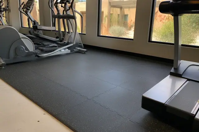 Interlocking rubber floor tiles installed in a commercial gym with cardio equipment in Scottsdale, AZ.