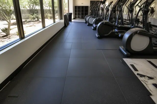 Interlocking rubber gym flooring installed around cardio equipment in a Peoria, AZ commercial gym.
