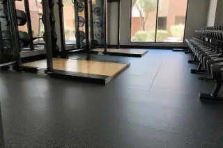 Rubber flooring installed beneath heavy lifting platforms in a corporate gym in Phoenix, AZ.
