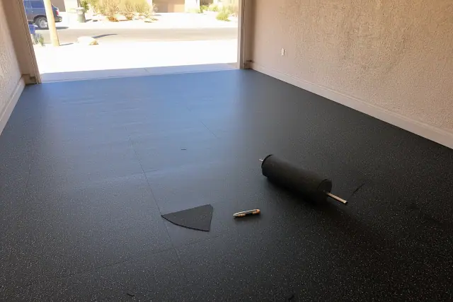 Rolled rubber flooring installation on a concrete garage floor in Phoenix, AZ.