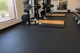 High-density rolled rubber flooring installed in a corporate fitness center in Phoenix, AZ, with desert views.