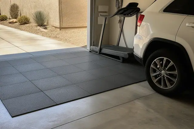 Square rubber floor tiles being installed on a concrete garage floor in Phoenix, AZ.