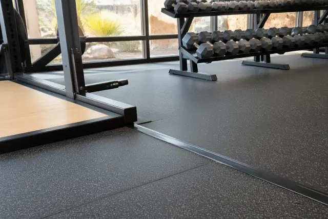High-density rubber flooring with scuff-resistant texture installed in a corporate fitness center in Phoenix, AZ.