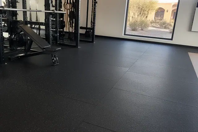 Heavy-duty rubber tile flooring installed on a concrete slab in a gym in Goodyear, AZ.