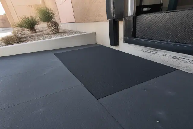 Rubber flooring repair near a concrete loading dock at a jobsite in Scottsdale, AZ.
