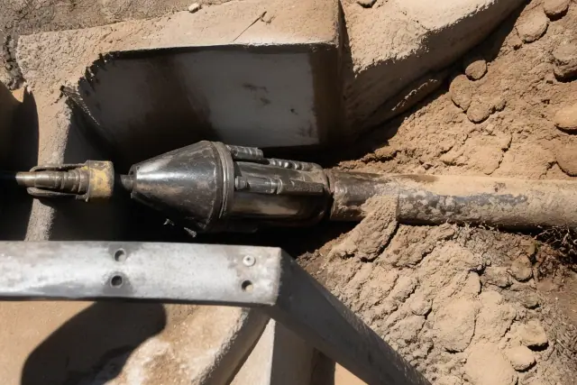 Hydraulic bursting head in a trenchless sewer pipe replacement pit at a job site in Phoenix, AZ.
