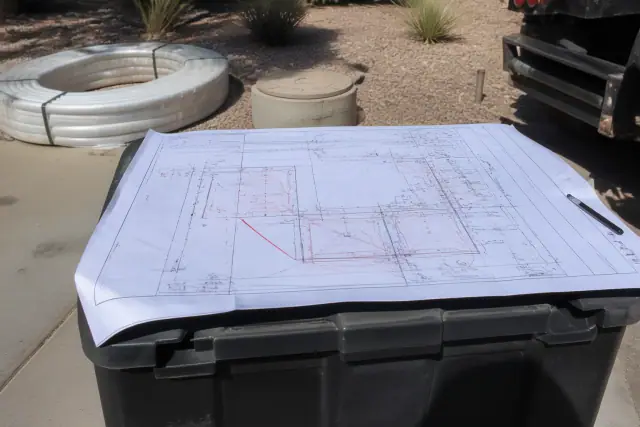 Commercial sewer repair site layout map with pipe markings on a tool crate in Phoenix, AZ.