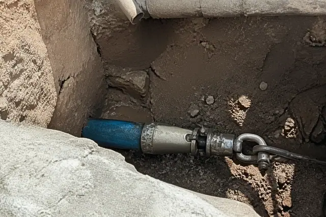 Hydraulic bursting head in a trenchless pipe replacement pit at a jobsite in Phoenix, AZ.