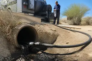 High-pressure hydro-jetting nozzle inside an industrial drainage pipe at a Phoenix, AZ jobsite.