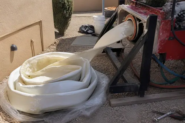 Resin-coated flexible liner being inserted into a pipe during a sewer lining project in Surprise, AZ.