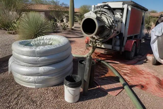 Resin-coated liner and hydraulic inversion machine at a sewer pipe lining jobsite in Goodyear, AZ.