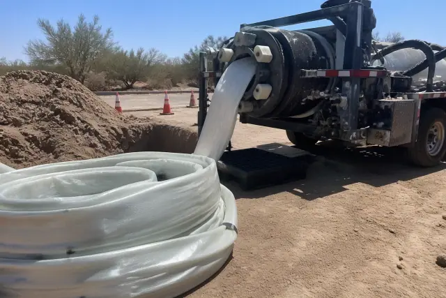 Resin-coated liner and a hydraulic inversion machine prepared for sewer pipe lining in Peoria, AZ.
