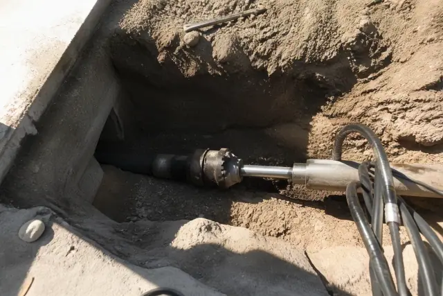 Hydraulic bursting head inside an entry pit during trenchless sewer repair work in Mesa, AZ.