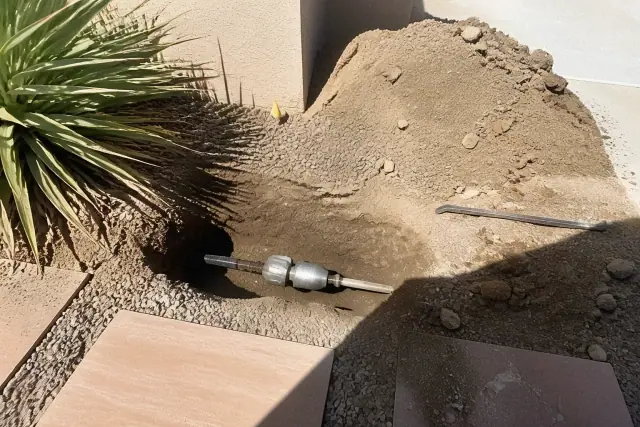 Hydraulic bursting head inside a trenchless sewer repair pit at a jobsite in Phoenix, AZ.