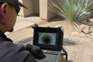 Smartphone screen showing a clean, cured sewer liner during a jobsite inspection in Phoenix, AZ.