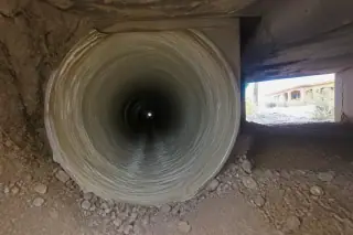 Cured resin lining inside a repaired sewer pipe within a residential crawlspace in Phoenix, AZ.