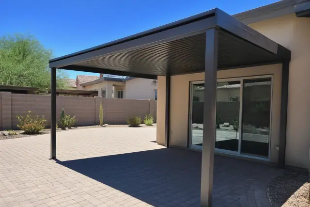 Aluminum ramada installed over a stone patio in Phoenix, AZ with desert landscaping.