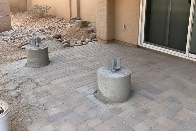 Concrete footing with a metal post bracket for a patio cover at a home in Phoenix, AZ.