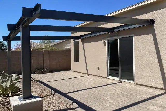 Cantilever shade structure with steel supports installed on a paved backyard patio in Mesa, AZ.