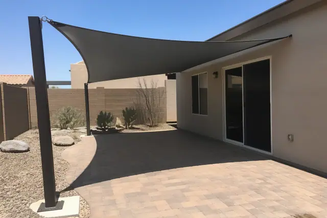 Cantilever shade structure with a fabric canopy over a residential patio in Peoria, AZ.