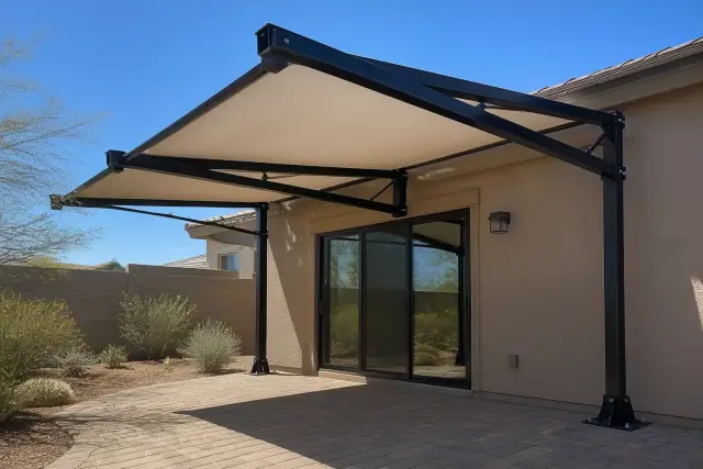 Cantilever shade structure installed over a paved patio in a residential backyard in Surprise, AZ.