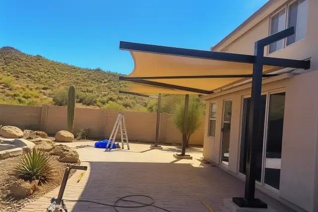 Cantilever shade structures over a residential patio in Phoenix, AZ with desert landscaping.