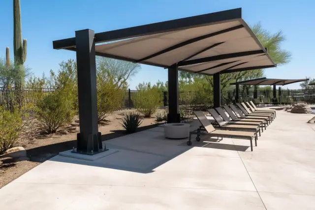 Cantilever shade structures with steel base plates installed at a commercial pool deck in Phoenix, AZ.