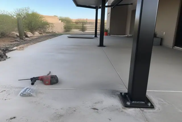 Structural steel carport installation on a residential concrete slab in Goodyear, AZ.