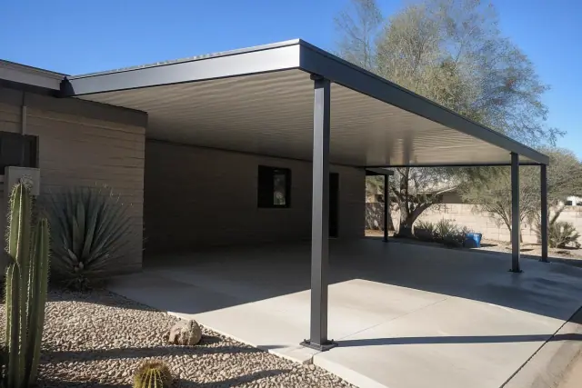 New carport shade structure over a concrete driveway in Tempe, AZ, featuring steel supports and silver roof panels.