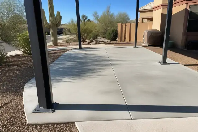 Steel carport support posts installed on a concrete driveway in Chandler, AZ.