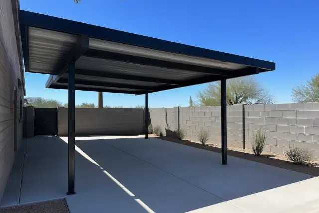 Newly installed metal carport and awning over a concrete driveway in Phoenix, AZ.
