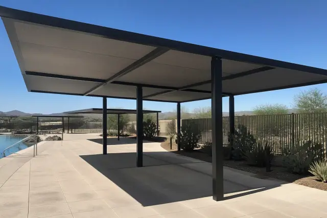 Commercial shade structure over a pool deck with desert landscaping in Phoenix, AZ.