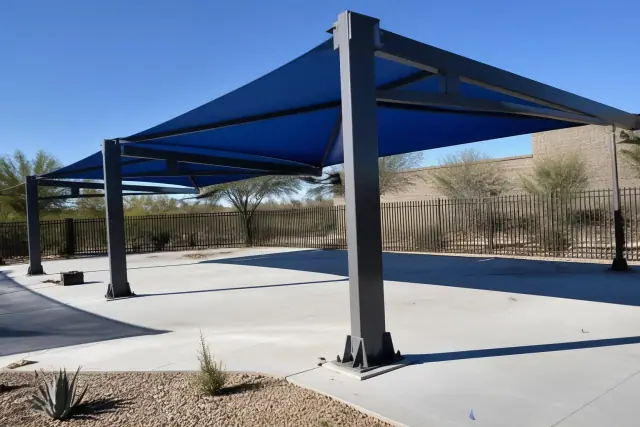 Commercial shade structures with steel mounting plates bolted to a concrete deck in Surprise, AZ.