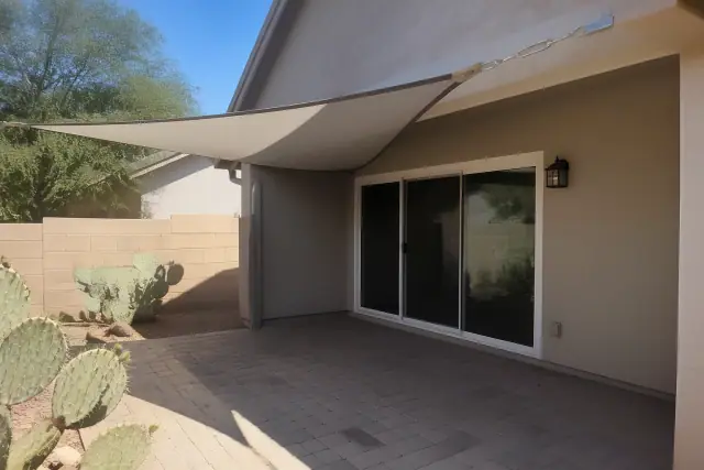 Tension-mounted sail shade installed over a residential patio in Phoenix, AZ.