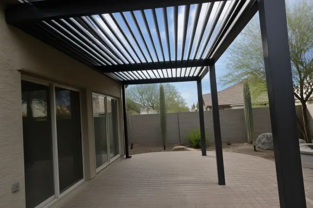 Custom louvered pergola with adjustable aluminum slats over a backyard patio in Phoenix, AZ.