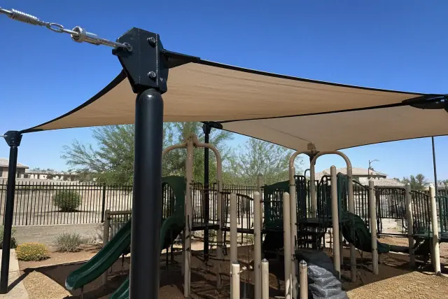 Custom playground shade structure with tensioned fabric and steel connectors at a park in Phoenix, AZ.