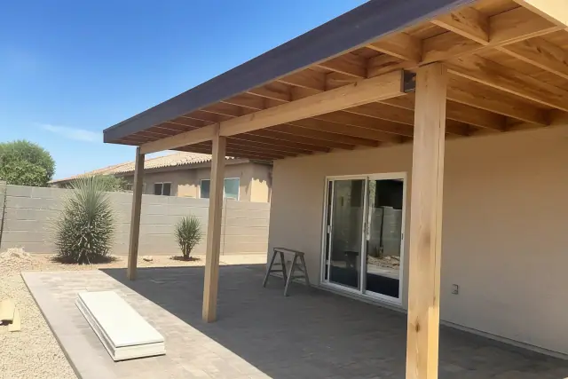 A custom ramada under construction on a residential backyard patio in Phoenix, AZ.