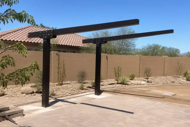 Double-cantilever shade structure installed over a xeriscaped residential patio in Phoenix, AZ.